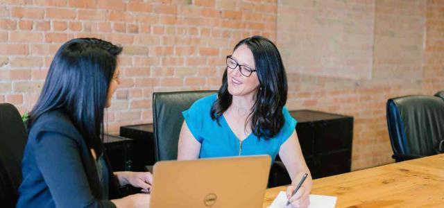 Two women meeting in an office space.